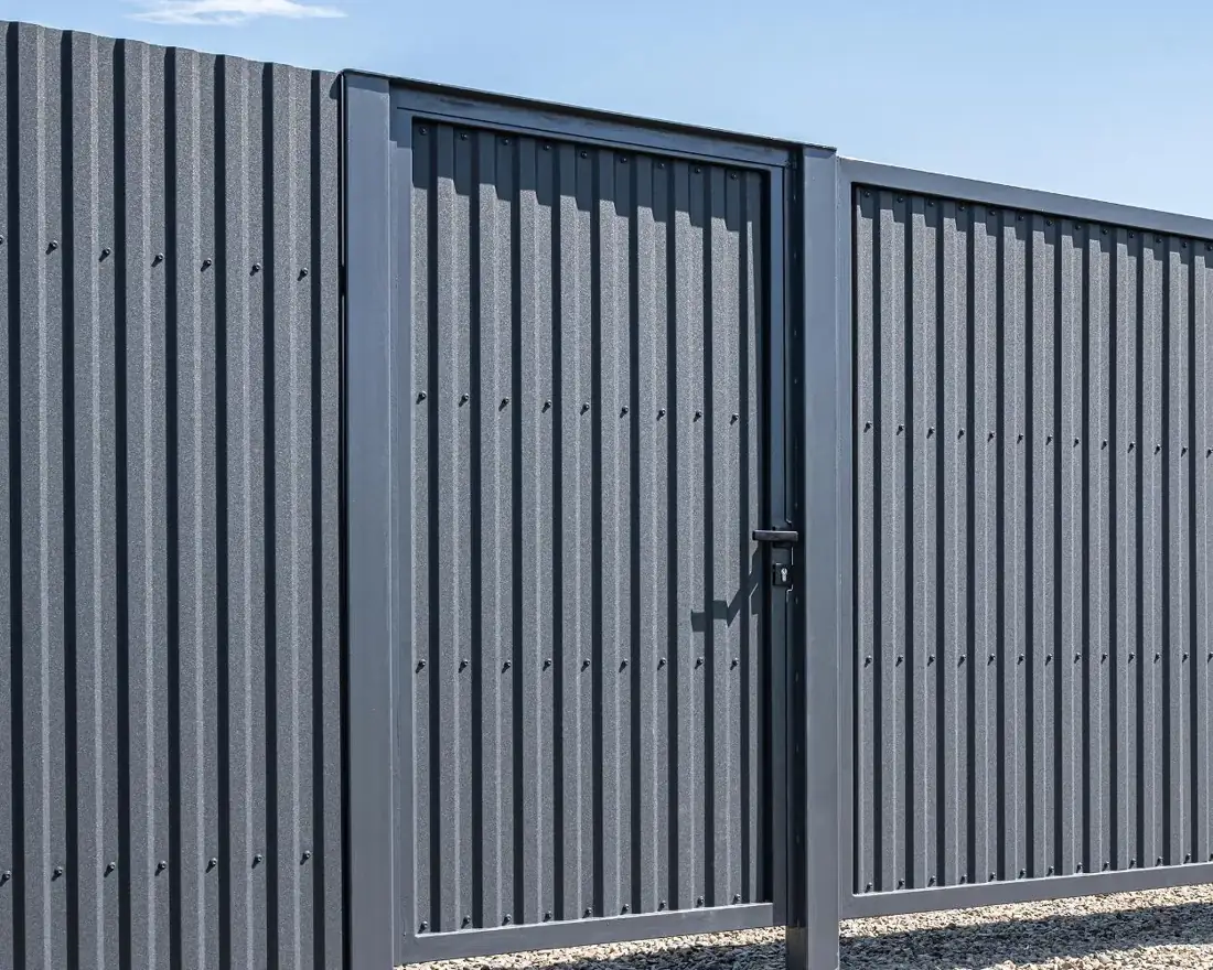 Grey steel security fencing with a lockable pedestrian door
